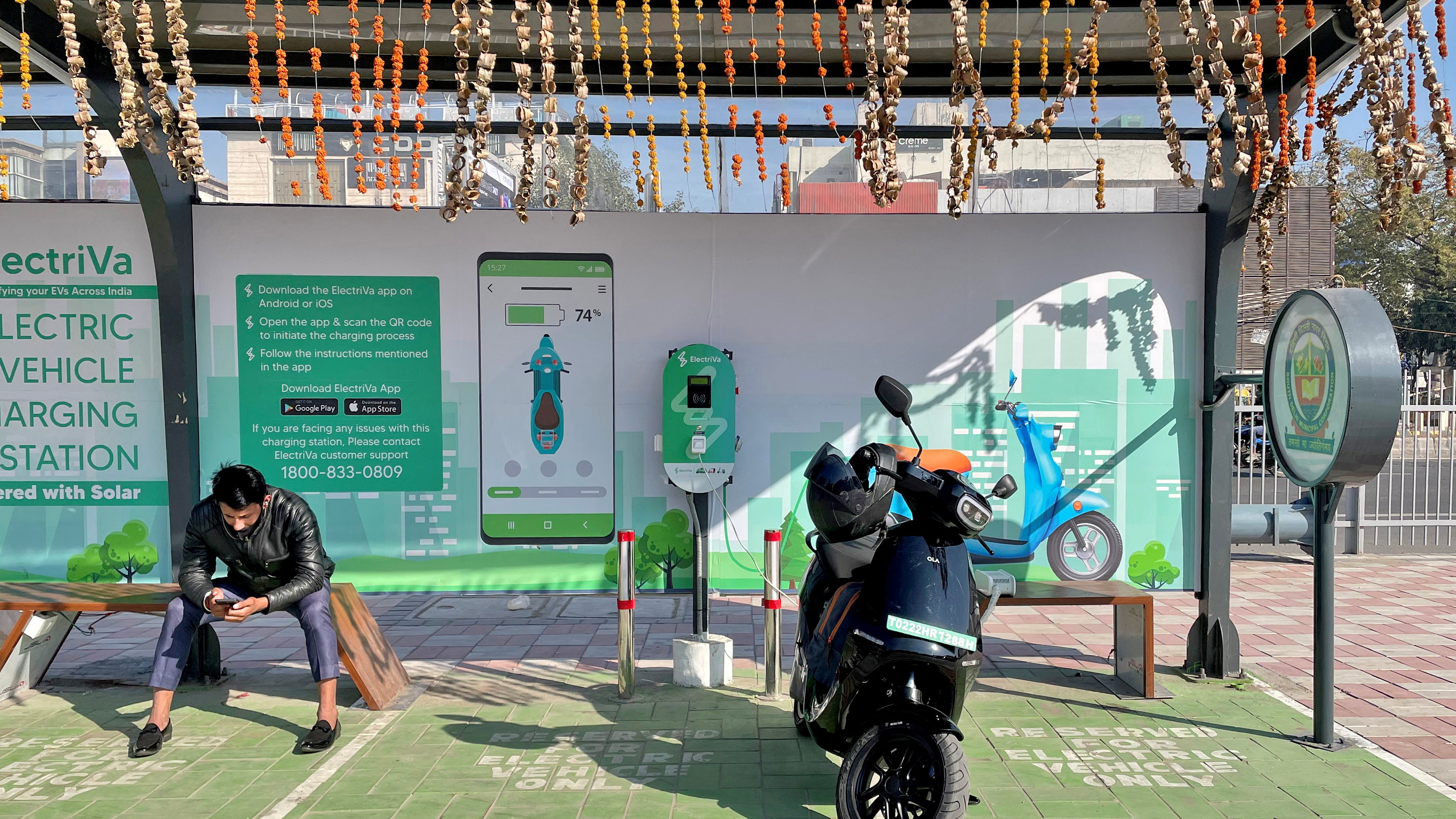 Ola electric scooter charging at a station in New Delhi, India.
Image Source: Reuters
