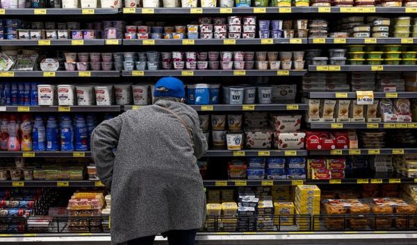 A man is buying food in a supermarket, which shows a high CPI and inflation