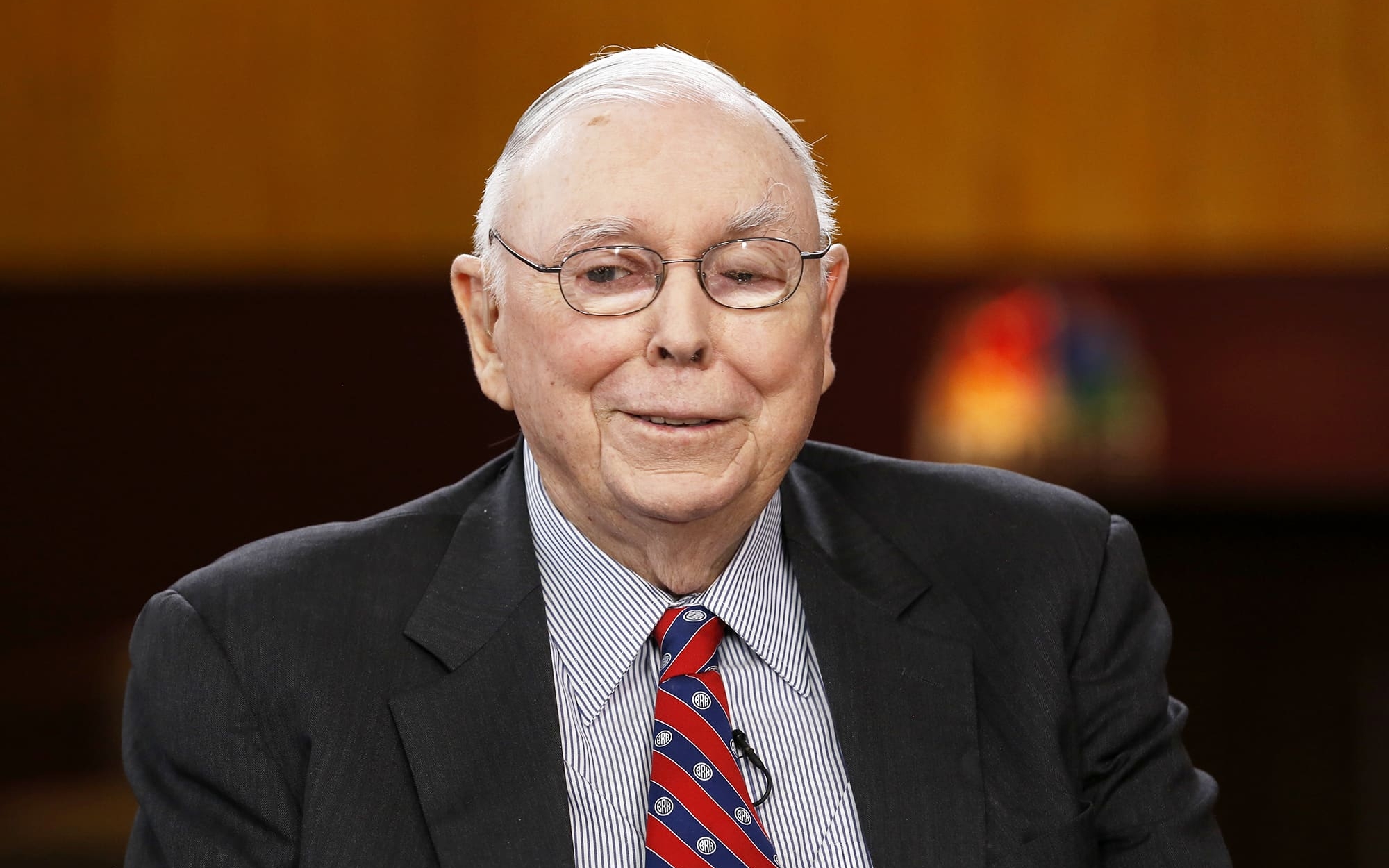 A photo of Berkshire Hathway’s Vice Chairman, Charlie Munger, captured with a smile. 

Image Source: CNBC 